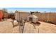 Backyard featuring goat standing on dog house, pig, sheds, and wooden fence at 11652 N 49Th Dr, Glendale, AZ 85304