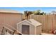 Backyard featuring goat standing on dog house, sheds and wooden fence at 11652 N 49Th Dr, Glendale, AZ 85304