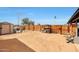 Spacious dirt backyard with storage shed, dog house, and wooden fence at 11652 N 49Th Dr, Glendale, AZ 85304
