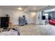 Open basement with tile flooring, multiple doors, and a mini fridge with room for storage at 11652 N 49Th Dr, Glendale, AZ 85304