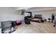 Spacious basement setup with a lounge chair, dog crate and bedroom area at 11652 N 49Th Dr, Glendale, AZ 85304