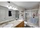 Updated bathroom features a granite countertop, double sinks, and a glass-enclosed shower at 11652 N 49Th Dr, Glendale, AZ 85304