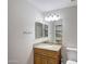 Bright bathroom featuring a granite countertop vanity, decorative mirror, and toilet at 11652 N 49Th Dr, Glendale, AZ 85304