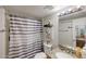 Bathroom with granite countertop, patterned shower curtain, and well-lit vanity at 11652 N 49Th Dr, Glendale, AZ 85304