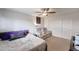 Cozy bedroom with a ceiling fan, comfortable seating area and ample closet space at 11652 N 49Th Dr, Glendale, AZ 85304