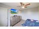 Comfortable bedroom featuring a ceiling fan, dresser, and a mounted TV at 11652 N 49Th Dr, Glendale, AZ 85304