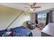 Cozy bedroom with a window view, recliner, and playful wall decor at 11652 N 49Th Dr, Glendale, AZ 85304