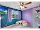 Bright bedroom with two tone walls, comfortable pink beanbag and a window overlooking the neighborhood at 11652 N 49Th Dr, Glendale, AZ 85304