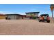 Two-story home with gravel landscaping, black motorcycle and orange Jeep out front at 11652 N 49Th Dr, Glendale, AZ 85304