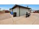 Gray house with a black motorcycle on the driveway next to the trash receptacles at 11652 N 49Th Dr, Glendale, AZ 85304