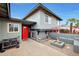 Gray home with a red front door and a small outdoor living space with a fire pit at 11652 N 49Th Dr, Glendale, AZ 85304
