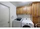 Functional laundry room with cabinetry, and modern washer and dryer units at 11652 N 49Th Dr, Glendale, AZ 85304