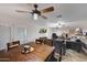 Open-concept living space with a dining table, ceiling fans, and a cozy seating area at 11652 N 49Th Dr, Glendale, AZ 85304