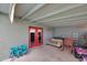 Covered patio provides a lounge area with red door access to the home at 11652 N 49Th Dr, Glendale, AZ 85304