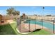 Inviting fenced pool area with a playset and artificial grass at 11652 N 49Th Dr, Glendale, AZ 85304