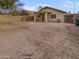 Spacious backyard featuring a gravel landscape, block wall, and covered patio at 11734 W Paradise Dr, El Mirage, AZ 85335