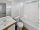 Bright bathroom with a shower-tub combo, a toilet and a vanity with a sink at 11734 W Paradise Dr, El Mirage, AZ 85335