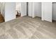 Bedroom with a large carpeted floor and a sliding-door closet and bathrooom at 11734 W Paradise Dr, El Mirage, AZ 85335