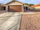 Charming single-story home showcasing a well-maintained front yard and attached two-car garage at 11734 W Paradise Dr, El Mirage, AZ 85335