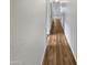Hallway with wood flooring and white walls leading to other rooms at 11734 W Paradise Dr, El Mirage, AZ 85335