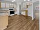 Open kitchen with ample counter space, white cabinets, pantry, and modern appliances at 11734 W Paradise Dr, El Mirage, AZ 85335