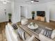 Bright living room with stylish decor, including a plush sofa, modern furniture, and wood flooring at 11734 W Paradise Dr, El Mirage, AZ 85335