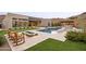 Stunning backyard with pool, built-in barbecue, putting green, and fire pit seating area at 14102 E Sonora Crest Dr, Fountain Hills, AZ 85268