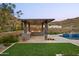 Outdoor barbecue with bar seating in a landscaped yard with a pool at 14102 E Sonora Crest Dr, Fountain Hills, AZ 85268