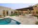 Outdoor kitchen with barbecue, bar seating, and view of pool and backyard at 14102 E Sonora Crest Dr, Fountain Hills, AZ 85268