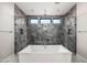 Bathroom with large soaking tub with marble tile, shower, and sleek design at 14102 E Sonora Crest Dr, Fountain Hills, AZ 85268