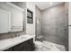 Modern bathroom featuring a tiled shower with glass door and a vanity with a white countertop and dark wood cabinets at 14102 E Sonora Crest Dr, Fountain Hills, AZ 85268