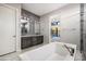 Bathroom featuring modern soaking tub, grey finishes, and door to outdoor living at 14102 E Sonora Crest Dr, Fountain Hills, AZ 85268