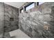 Modern shower with marble tile, dual shower heads, and built-in shelving at 14102 E Sonora Crest Dr, Fountain Hills, AZ 85268