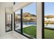Stunning view from inside shows the pool, putting green, outdoor seating and desert landscape at 14102 E Sonora Crest Dr, Fountain Hills, AZ 85268