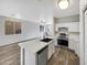 Bright kitchen featuring a quartz countertop island and stainless steel appliances at 1420 E Sonrisas St, Phoenix, AZ 85040