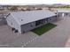 Exterior view of single-story home with spacious backyard and detached garage at 1455 E Dove Pl, Casa Grande, AZ 85122