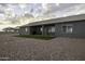 The backyard features a covered patio with seating, ideal for relaxing or entertaining outdoors at 1455 E Dove Pl, Casa Grande, AZ 85122