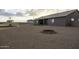 The backyard is a gravel landscape with a fire pit, great for enjoying outdoor evenings at 1455 E Dove Pl, Casa Grande, AZ 85122