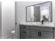 Powder room with quartz countertops, gray cabinets with black hardware, and a modern mirror at 1455 E Dove Pl, Casa Grande, AZ 85122