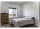 Bright bedroom featuring neutral paint, carpet, and a window letting in natural light at 1455 E Dove Pl, Casa Grande, AZ 85122