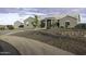 Beautiful front yard featuring an elegant circular driveway, desert landscaping, and mature trees at 1455 E Dove Pl, Casa Grande, AZ 85122
