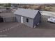 Detached building featuring stucco walls, a gray roof, and a gravel yard at 1455 E Dove Pl, Casa Grande, AZ 85122