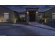 Beautiful single-story home featuring desert landscaping, decorative lighting, and a charming front entry at twilight at 1455 E Dove Pl, Casa Grande, AZ 85122