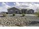 An exterior image of the home with rock landscaping and horseshoe driveway at 1455 E Dove Pl, Casa Grande, AZ 85122