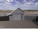 Detached gray garage with gate entrance in a serene setting at 1455 E Dove Pl, Casa Grande, AZ 85122