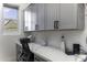 Well-equipped home office with custom cabinets, quartz countertops, and natural light at 1455 E Dove Pl, Casa Grande, AZ 85122