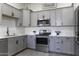 Modern kitchen with stainless steel appliances, gray cabinets, and countertops at 1455 E Dove Pl, Casa Grande, AZ 85122