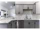 Modern kitchen with stainless steel appliances, gray cabinets, and countertops at 1455 E Dove Pl, Casa Grande, AZ 85122