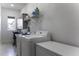 Functional laundry room with sleek appliances, storage cabinets, and convenient workspace at 1455 E Dove Pl, Casa Grande, AZ 85122