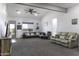 Spacious living room with vaulted ceilings, neutral carpet and comfortable seating at 1455 E Dove Pl, Casa Grande, AZ 85122